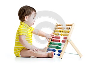 Baby playing with abacus toy. Concept of early