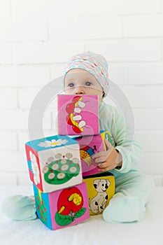 Baby playing with alphabet cube