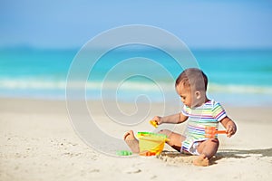 Baby playing on beach. Children play at sea