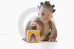 Baby playing with block