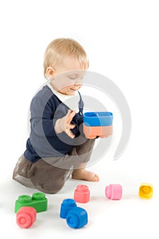 Baby playing with blocks on white background