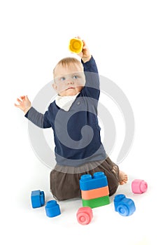Baby playing with blocks on white background