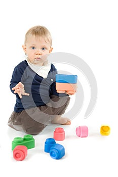 Baby playing with blocks on white background