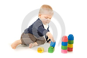 Baby playing with blocks on white background