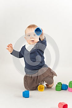 Baby playing with blocks on white background