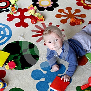 Baby playing on carpet