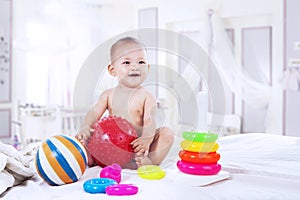 Baby playing with colorful toys