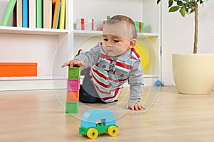 Baby playing with cubes and bricks