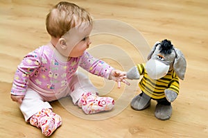 Baby playing with cuddly toy photo