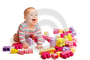 Baby playing in designer toy blocks