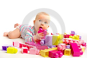 Baby playing in designer toy blocks