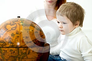 Baby playing with earths globe photo