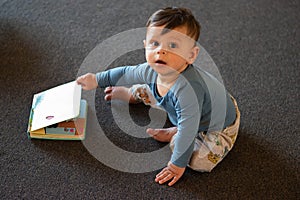 A baby playing on the floor