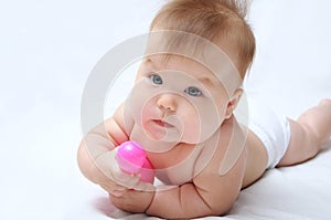 Baby playing and holding skittle for bowling
