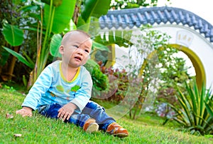 A baby playing on the lawn(Asia, China, Chinese)