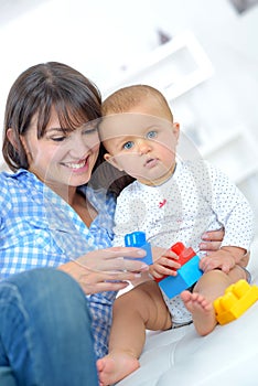 Baby playing lego with mum