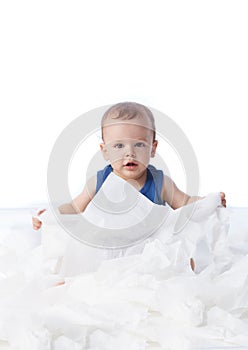 Baby playing with lots tissue papers