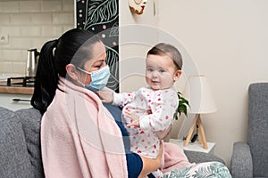 Baby playing with mother feeling sick wearing disposable mask