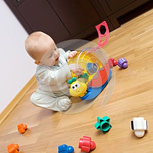 Baby playing with plastic toy