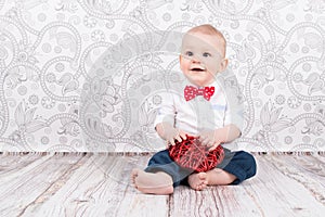 Baby playing with red heart