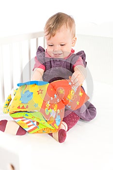 Baby playing with soft toy