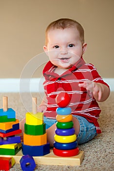 Baby playing with stacking learning toy