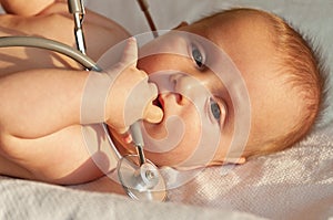 Baby playing with a stethoscope