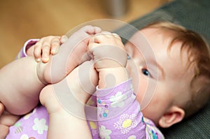 Baby playing with toes photo