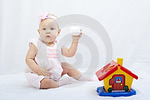 Baby is playing with toys over white background