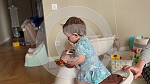 baby plays bike indoors. happy family a kid dream concept. baby girl riding a children's scooter in the room indoors