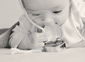 Baby plays with a box with an engagement rings