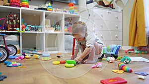 baby plays with pyramid toy. happy family a kid dream concept. baby plays pyramid with mugs in the playroom at home