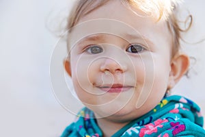 Baby plays snot in the street with a cold nose. Selective focus.