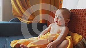 baby portrait. baby son sitting on the couch watching TV cartoons. happy family kid dream concept. baby toddler close-up