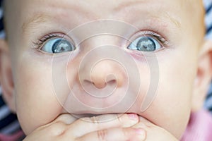 Baby portrait. Closeup face with bright blue eyes. Adorable baby