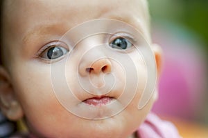 Baby portrait. Closeup face with bright blue eyes. Adorable baby