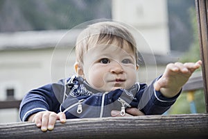 Baby pulling her arm while looking away