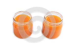 Baby puree with pumpkin, persimmon, mango in glass jar isolated on white, side view