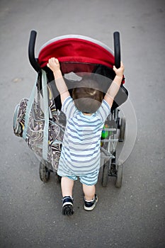 Baby pushing stroller
