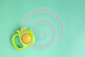 Baby rattle on green background