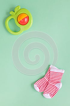 Baby rattle on green background