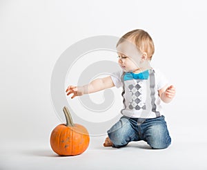 Baby Reaches for Pumpkin Interested