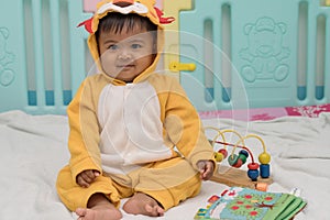 baby reading the book in room