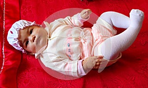 Baby on red bed