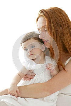 Baby and redhead mother hug on white