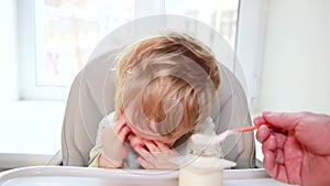 The baby refuses to eat children`s cottage cheese from a jar