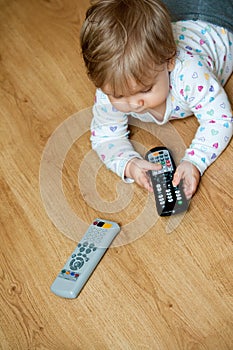 Baby with remote controls photo