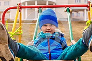 Baby rides a swing