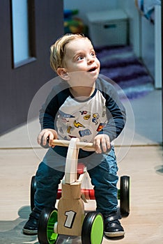 Baby riding toy car. Isolated