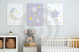 Baby room with crib and cute posters on wall